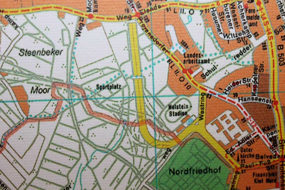 Stadtplan von 1977. Die Stadtautobahn ist fertig und trennt das Holstein-Stadion von den Hoheluft-„Sportplätzen“. Die Brücke verbindet die Holstein-Sportstätten. Über die Hoheluft-Sportplätze ist bereits der geplante Holstein-Kreisel verzeichnet. Stadtplan von 1977. Die Stadtautobahn ist fertig und trennt das Holstein-Stadion von den Hoheluft-„Sportplätzen“. Die Brücke verbindet die Holstein-Sportstätten. Über die Hoheluft-Sportplätze ist bereits der geplante Holstein-Kreisel verzeichnet.